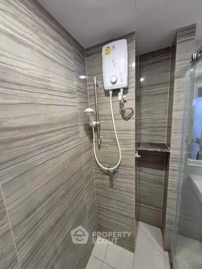 Modern bathroom with sleek tiles and electric shower unit