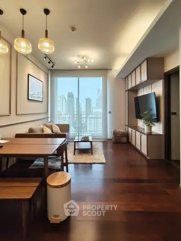 Modern living room with city view, elegant decor, and wooden flooring.
