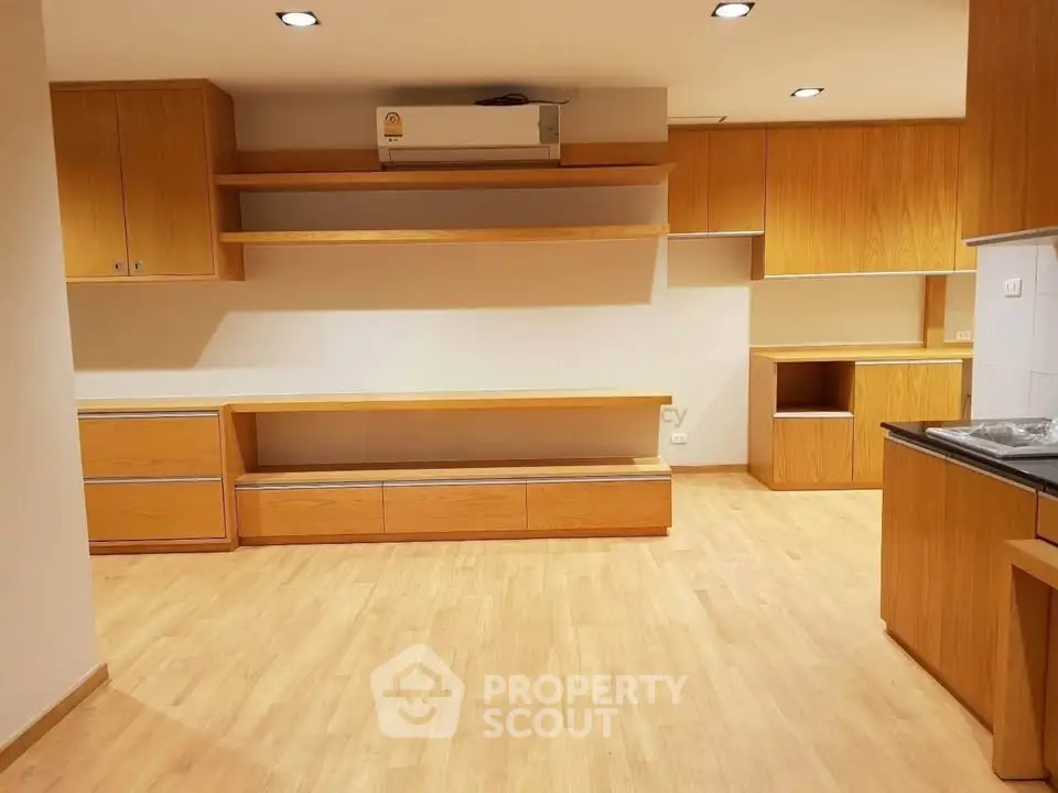 Spacious modern kitchen with wooden cabinetry and sleek design