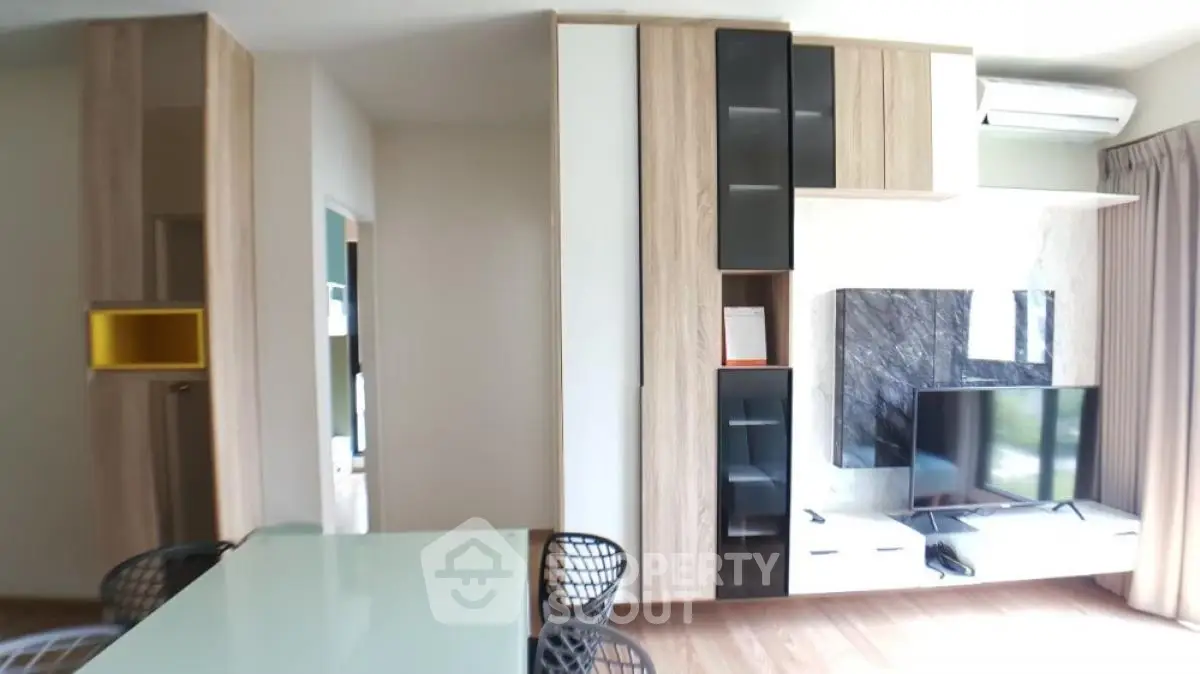 Modern living room with stylish furniture and wall-mounted TV