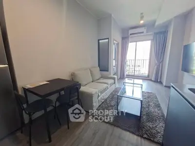 Modern living room with cozy sofa, dining table, and balcony view in stylish apartment.