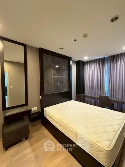 Modern bedroom with stylish decor and large window in a luxury apartment.