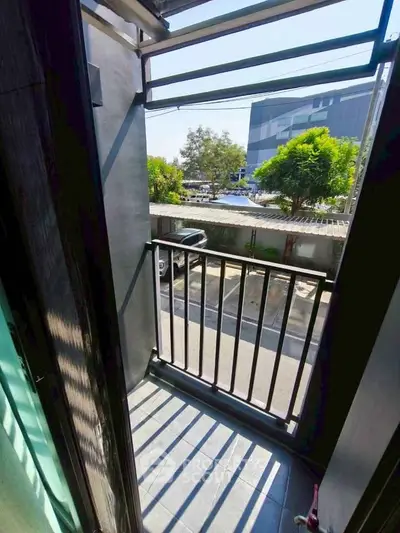 Charming small balcony with street view, perfect for urban living.