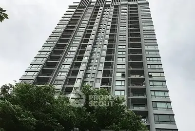 Stunning high-rise building with modern architecture and lush greenery.