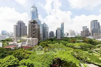 Stunning cityscape view with lush greenery and modern skyscrapers under a bright sky.