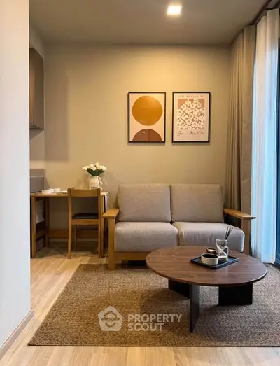 Modern living room with cozy sofa, stylish coffee table, and elegant wall art in a chic apartment.