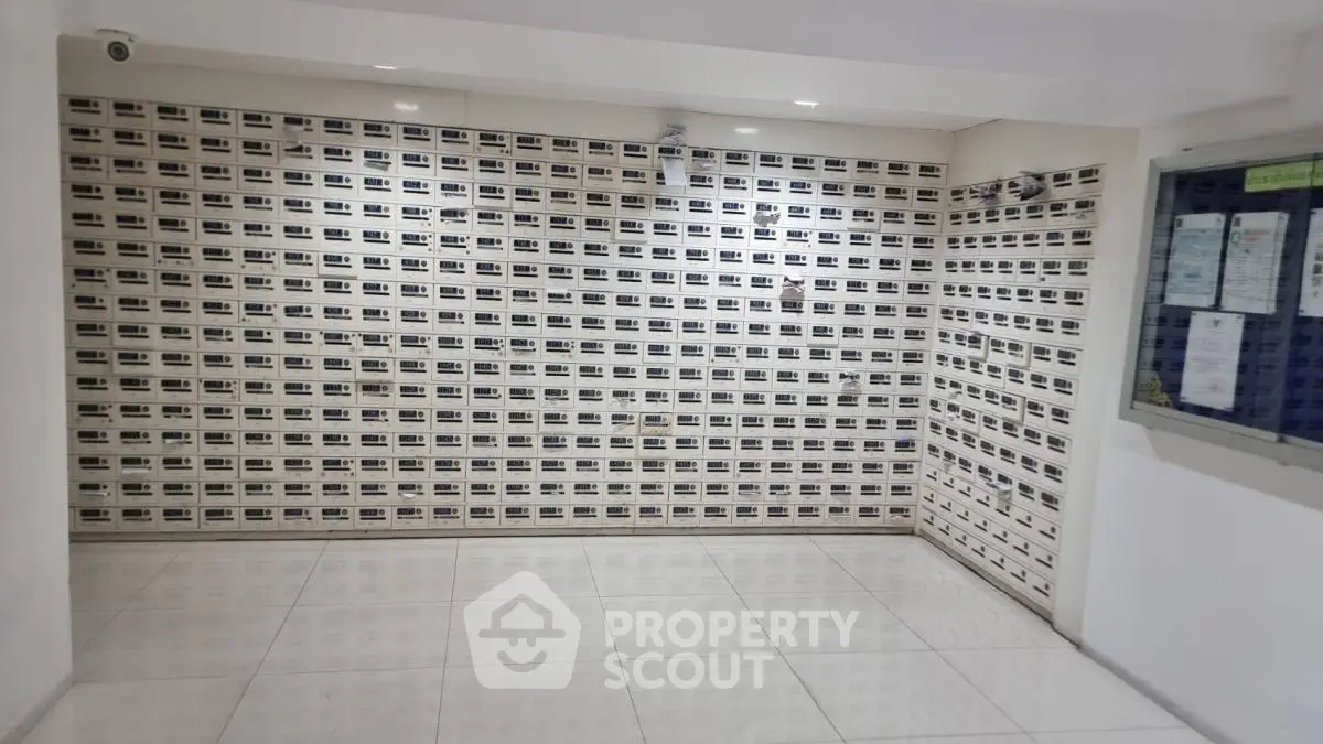 Spacious apartment lobby with modern mailboxes and tiled flooring