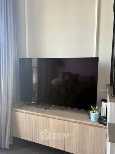 Modern living room with sleek TV setup and stylish cabinet