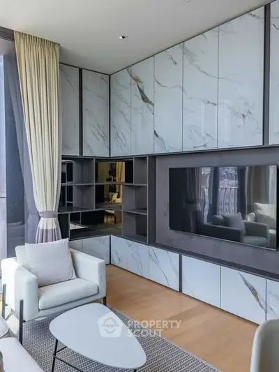 Luxurious modern living room with marble accents and large TV