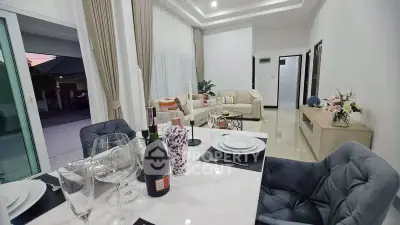 Elegant open-plan living and dining area with modern decor and ample natural light.