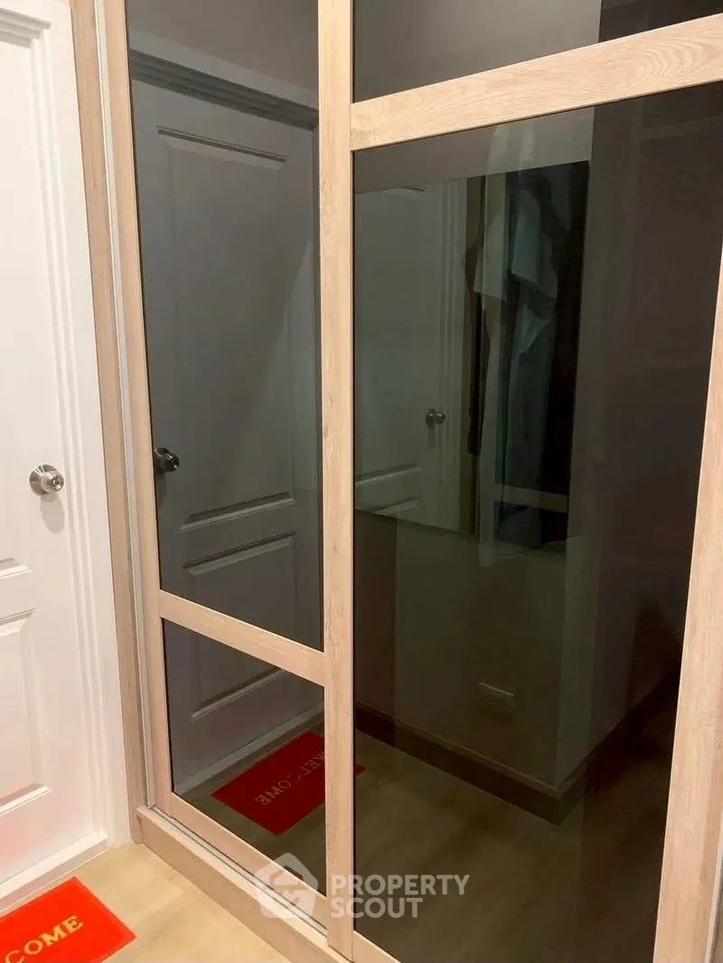 Modern interior with sleek mirrored wardrobe and wooden flooring