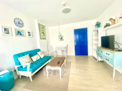 Charming living room with vibrant blue accents and cozy seating area.