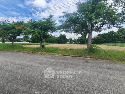 Spacious land plot with lush greenery and clear skies, perfect for development opportunities.
