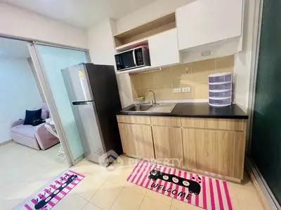 Modern kitchen with sleek appliances and stylish decor in a cozy apartment setting.