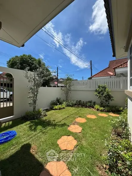 Charming garden with stepping stones in a sunny residential backyard, perfect for outdoor relaxation.