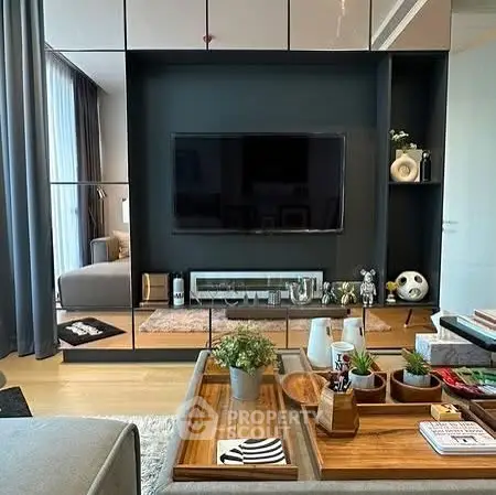 Stylish modern living room with sleek decor and entertainment center.