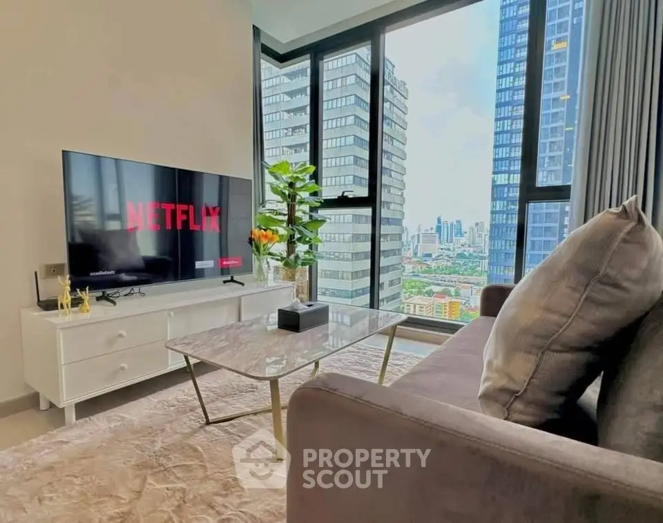 Modern living room with stunning city view, featuring sleek furniture and large windows.