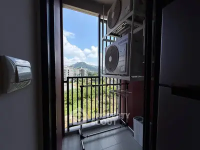 Charming balcony with scenic view and modern appliances, perfect for relaxation and utility in urban living.