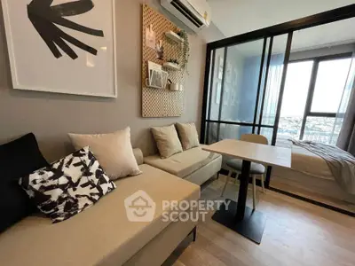 Modern living room with stylish decor and city view, featuring cozy seating and dining area.