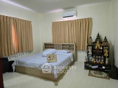 Cozy bedroom with air conditioning and serene decor, perfect for relaxation and comfort.
