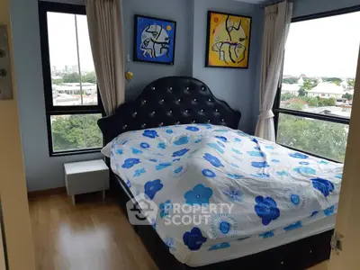 Bright bedroom with large windows and stylish decor offering a scenic view.