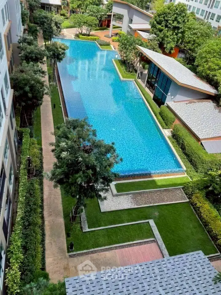 Luxurious apartment complex with stunning pool and lush greenery
