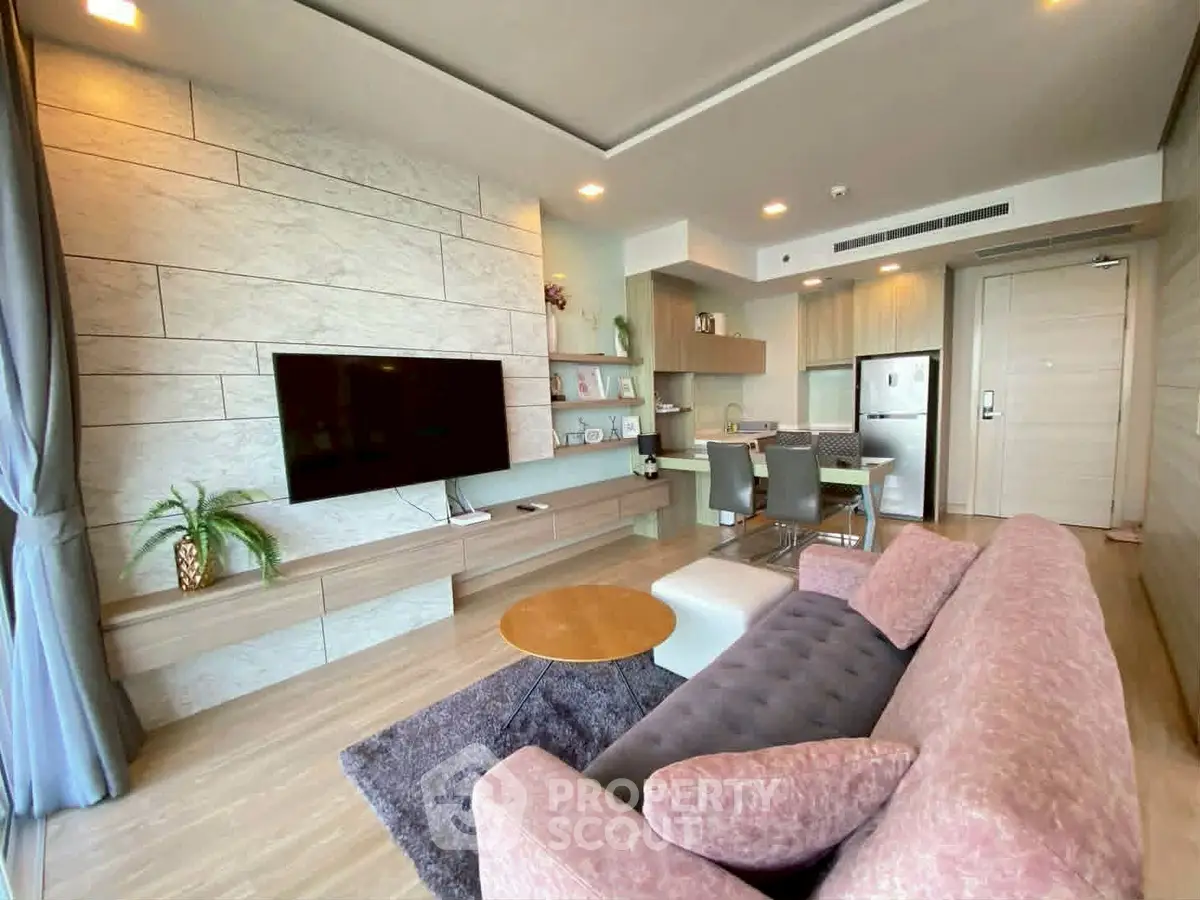 Modern living room with stylish decor and open kitchen layout in a luxury apartment.