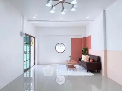 Spacious modern living room with stylish decor and large windows for natural light.