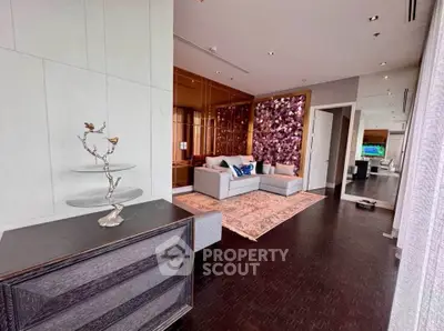 Luxurious living room with elegant decor and modern furniture, featuring a unique wall design and spacious layout.