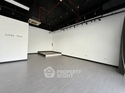 Spacious commercial interior with modern design and high ceilings, perfect for retail or office space.