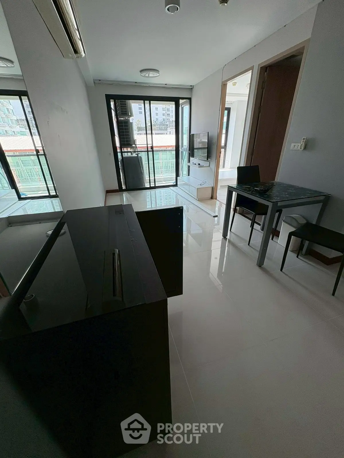 Modern living room with sleek furniture and balcony view in urban apartment