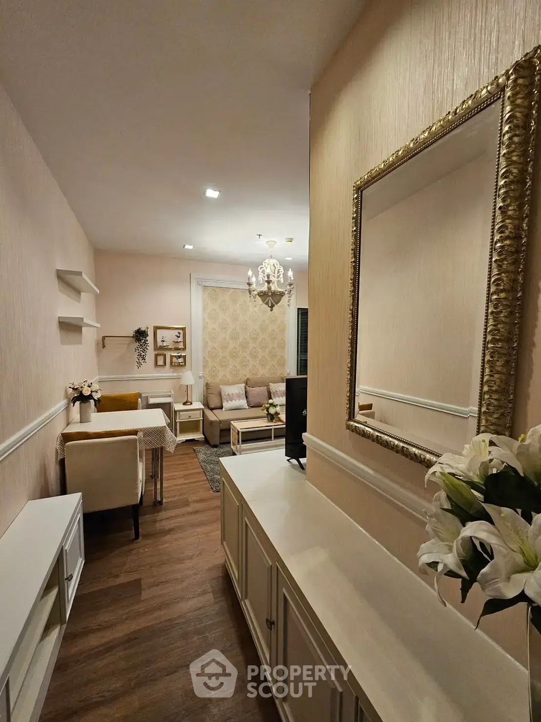 Elegant living room with chandelier and stylish decor in modern apartment