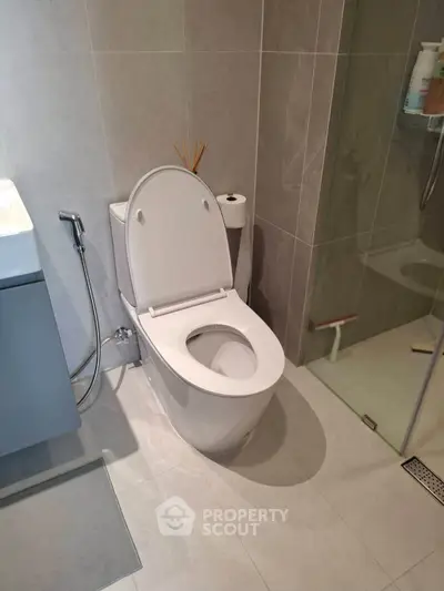 Modern bathroom with sleek toilet and glass shower enclosure