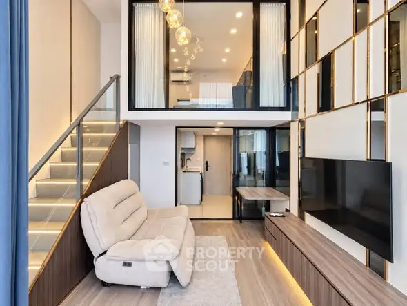 Modern duplex living room with stylish decor and open kitchen layout