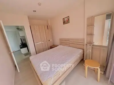 Spacious bedroom with modern wooden furniture and natural light