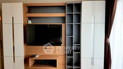 Modern living room with sleek TV unit and ample storage space