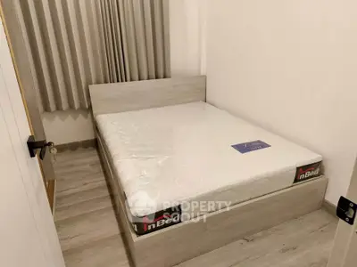 Cozy bedroom with modern bed frame and neutral decor, perfect for restful nights.