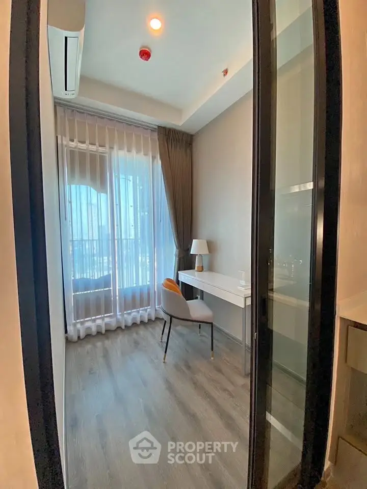 Modern study room with sleek design and ample natural light, featuring a stylish desk and chair.