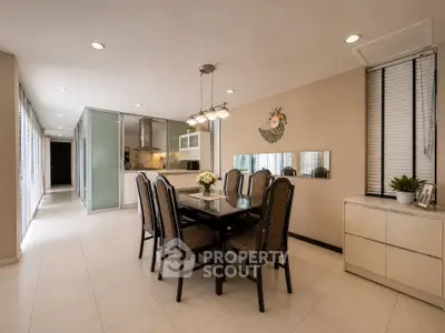 Elegant dining area with modern decor and open kitchen layout in a stylish home.