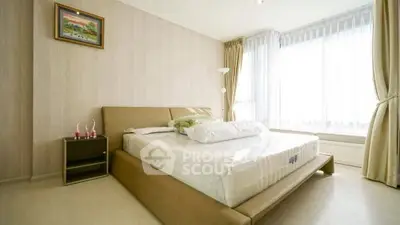 Bright and cozy bedroom with large windows and modern decor