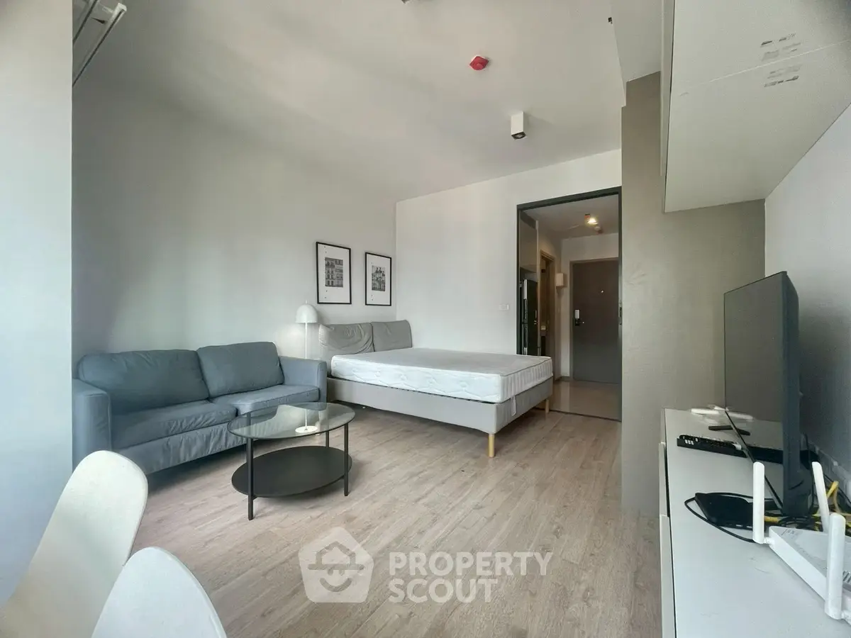 Modern studio apartment with sleek furnishings and natural light