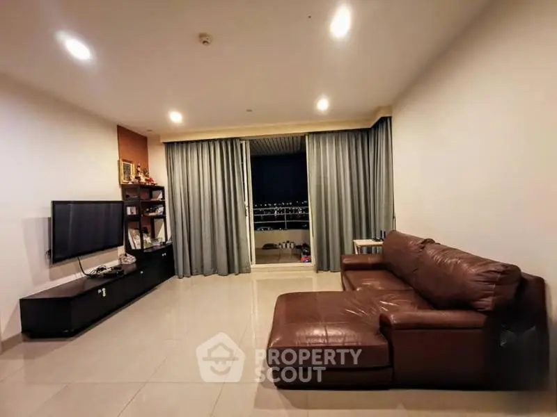Spacious living room with modern decor and balcony view