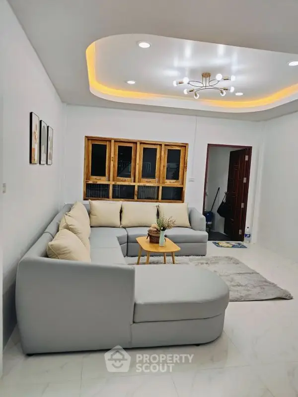 Modern living room with stylish sectional sofa and elegant ceiling lighting