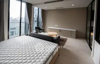 Spacious modern bedroom with large windows and city view