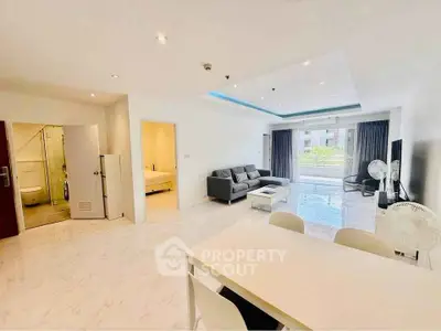 Spacious modern living room with open layout and large windows offering natural light.