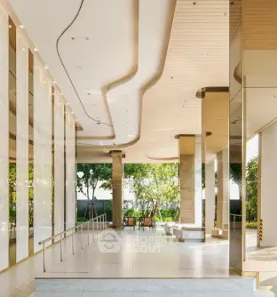 Luxurious building entrance with modern design and lush greenery