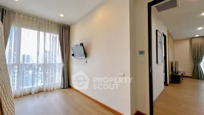 Bright modern apartment with large windows and wooden flooring