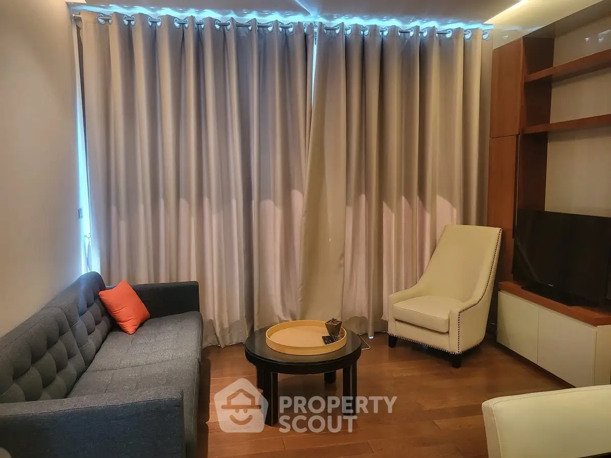 Cozy living room with modern furniture and elegant curtains, perfect for relaxation and entertainment.