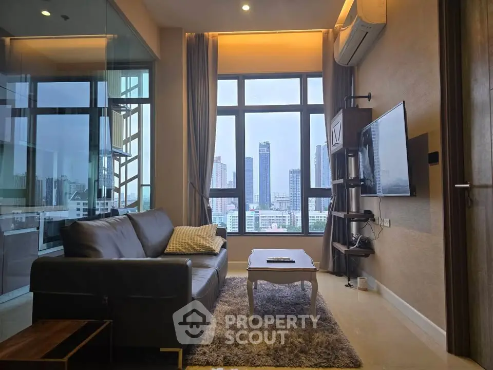 Luxurious living room with stunning city view, modern furnishings, and ample natural light.
