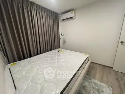 Cozy bedroom with air conditioning and elegant curtains, perfect for restful nights.
